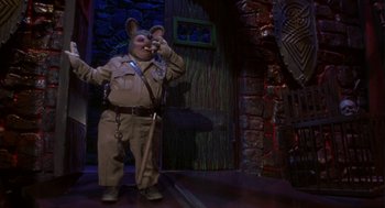 Movie still from “Monkeybone” (2001), directed by Henry Selick – A man in a uniform is holding a cell phone; Medium shot, Low angle