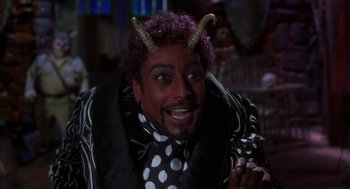 Movie still from “Monkeybone” (2001), directed by Henry Selick – A man with horns on his head is smiling for the camera; Close Up shot, Over the shoulder angle