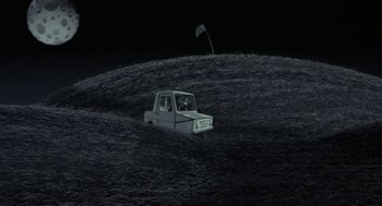 Movie still from “Monkeybone” (2001), directed by Henry Selick – A white truck is in a field at night; Extreme Wide shot, High angle