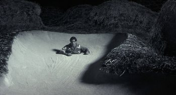 Movie still from “Monkeybone” (2001), directed by Henry Selick – A man laying on the ground in the dirt; Wide shot, High angle