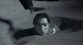 Movie still from “Monkeybone” (2001), directed by Henry Selick – A man laying on the ground looking at the camera; Close Up shot, High angle