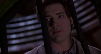 Movie still from “Monkeybone” (2001), directed by Henry Selick – A person behind bars; Close Up shot, Low angle