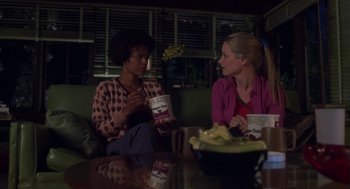 Movie still from “Monkeybone” (2001), directed by Henry Selick – Two women are sitting at a table and talking to each other; Medium shot, Over the shoulder angle