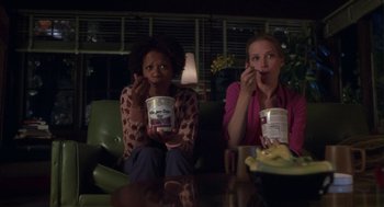 Movie still from “Monkeybone” (2001), directed by Henry Selick – Two women are sitting at a table with food and drinks; Medium shot, High angle