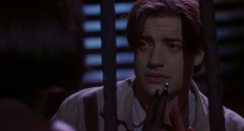 Movie still from “Monkeybone” (2001), directed by Henry Selick – A young man with long brown hair is looking into the mirror; Close Up shot, Over the shoulder angle