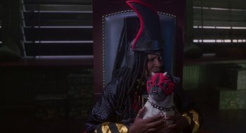 Movie still from “Monkeybone” (2001), directed by Henry Selick – A woman dressed up as a witch holding a dog; Medium shot, High angle