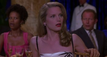 Movie still from “Monkeybone” (2001), directed by Henry Selick – A woman sitting at a table in front of a glass of wine; Close Up shot, Over the shoulder angle