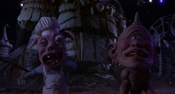 Movie still from “Monkeybone” (2001), directed by Henry Selick – View of a troll and a troll doll; Medium shot, Low angle