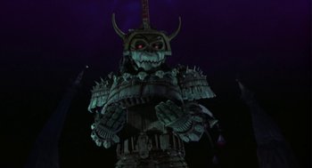 Movie still from “Monkeybone” (2001), directed by Henry Selick – A statue of a person wearing a costume; Wide shot, Low angle