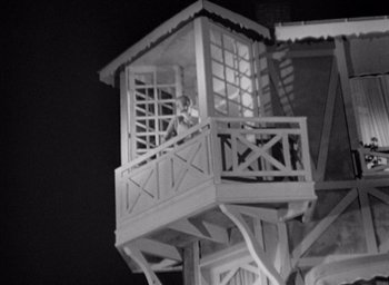 Movie still from “Monsieur Hulot's Holiday” (1953), directed by Jacques Tati – A black - and - white photo of a person in a tower; Extreme Wide shot, Low angle