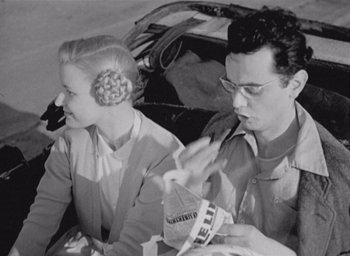 Movie still from “Monsieur Hulot's Holiday” (1953), directed by Jacques Tati – A man and a woman sitting next to each other; Medium shot, High angle