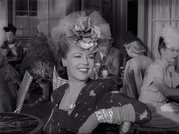 Movie still from “Monsieur Verdoux” (1947), directed by Charles Chaplin – An old photo of a woman wearing a hat and gloves; Medium shot, Low angle