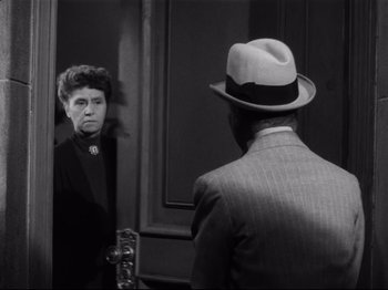 Movie still from “Monsieur Verdoux” (1947), directed by Charles Chaplin – An old photo of a man and a woman looking in the same mirror; Medium shot, Over the shoulder angle