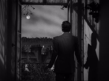 Movie still from “Monsieur Verdoux” (1947), directed by Charles Chaplin – A black and white photo of a man looking out of a window; Medium shot, Low angle