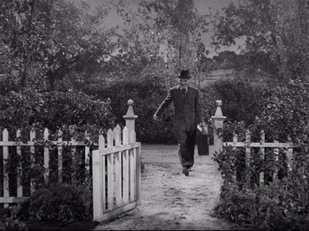 Movie still from “Monsieur Verdoux” (1947), directed by Charles Chaplin – A man walking down a path in a garden; Wide shot, High angle