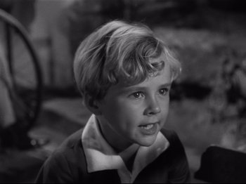 Movie still from “Monsieur Verdoux” (1947), directed by Charles Chaplin – A young boy with blonde hair sitting in a room; Close Up shot, High angle