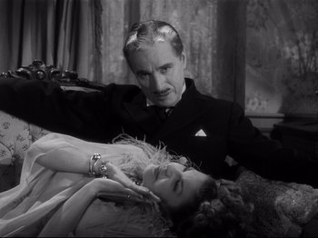 Movie still from “Monsieur Verdoux” (1947), directed by Charles Chaplin – A black and white photo of a man and a woman; Medium shot, High angle