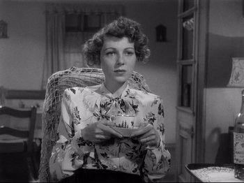 Movie still from “Monsieur Verdoux” (1947), directed by Charles Chaplin – A black and white photo of a woman holding a cup; Medium shot, High angle