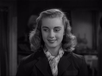 Movie still from “Monsieur Verdoux” (1947), directed by Charles Chaplin – A young woman in a suit and tie; Close Up shot, Over the shoulder angle