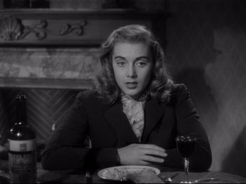 Movie still from “Monsieur Verdoux” (1947), directed by Charles Chaplin – A woman sitting at a table with a glass of wine; Close Up shot, Over the shoulder angle