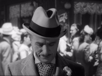 Movie still from “Monsieur Verdoux” (1947), directed by Charles Chaplin – A black and white photo of a man wearing a hat; Close Up shot, High angle