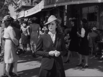 Movie still from “Monsieur Verdoux” (1947), directed by Charles Chaplin – An old photo of a woman wearing a hat in the street; Medium shot, Low angle