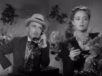 Movie still from “Monsieur Verdoux” (1947), directed by Charles Chaplin – A man and a woman on the phone; Medium shot, Low angle