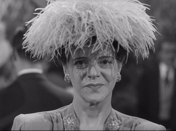 Movie still from “Monsieur Verdoux” (1947), directed by Charles Chaplin – A black and white photo of a woman wearing a feather hat; Close Up shot, Low angle