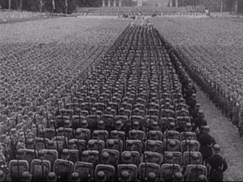 Movie still from “Monsieur Verdoux” (1947), directed by Charles Chaplin – Rows of seats are lined up in a field; Extreme Wide shot, High angle