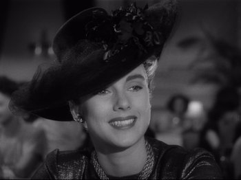 Movie still from “Monsieur Verdoux” (1947), directed by Charles Chaplin – A black and white photo of a woman wearing a hat; Close Up shot, Low angle