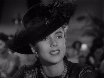Movie still from “Monsieur Verdoux” (1947), directed by Charles Chaplin – A black and white photo of a woman wearing a hat; Close Up shot, Low angle