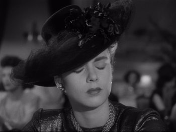 Movie still from “Monsieur Verdoux” (1947), directed by Charles Chaplin – A black and white photo of a woman wearing a hat; Close Up shot, Low angle
