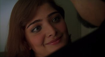 Movie still from “Monsoon Wedding” (2001), directed by Mira Nair – A young woman's face with green eyes; Close Up shot, Over the shoulder angle
