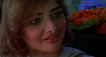 Movie still from “Monsoon Wedding” (2001), directed by Mira Nair – A young woman's face with flowers in the background; Close Up shot, High angle