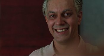 Movie still from “Monsoon Wedding” (2001), directed by Mira Nair – A person smiling; Close Up shot, Low angle