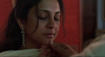 Movie still from “Monsoon Wedding” (2001), directed by Mira Nair – A person touching a woman's face; Close Up shot, Low angle