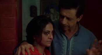 Movie still from “Monsoon Wedding” (2001), directed by Mira Nair – A man and a woman standing next to each other; Close Up shot, High angle