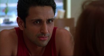 Movie still from “Monsoon Wedding” (2001), directed by Mira Nair – A person with a red shirt on; Close Up shot, Over the shoulder angle