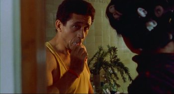 Movie still from “Monsoon Wedding” (2001), directed by Mira Nair – A man brushing his teeth in the bathroom; Close Up shot, Low angle