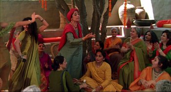 Movie still from “Monsoon Wedding” (2001), directed by Mira Nair – A group of women sitting around a tree; Wide shot, High angle