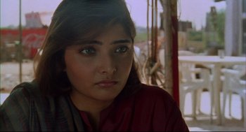 Movie still from “Monsoon Wedding” (2001), directed by Mira Nair – A person wearing a red shirt; Close Up shot, High angle