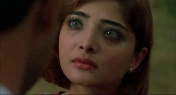 Movie still from “Monsoon Wedding” (2001), directed by Mira Nair – A person with green eyes; Close Up shot, Over the shoulder angle