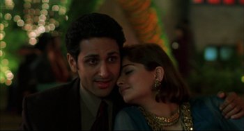 Movie still from “Monsoon Wedding” (2001), directed by Mira Nair – A man and a woman are posing for a picture; Close Up shot, Low angle