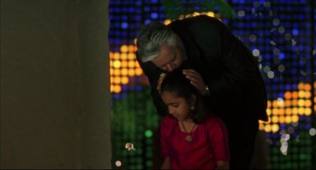 Movie still from “Monsoon Wedding” (2001), directed by Mira Nair – An older woman combs the hair of a young girl; Medium shot, Low angle