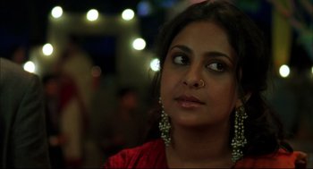 Movie still from “Monsoon Wedding” (2001), directed by Mira Nair – A person wearing a red shirt; Close Up shot, Over the shoulder angle