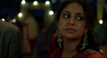 Movie still from “Monsoon Wedding” (2001), directed by Mira Nair – A person wearing a red dress; Close Up shot, Over the shoulder angle