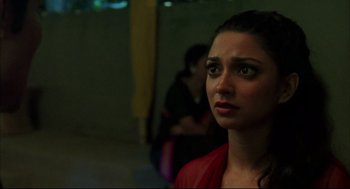 Movie still from “Monsoon Wedding” (2001), directed by Mira Nair – A person looking at the camera; Close Up shot, Over the shoulder angle