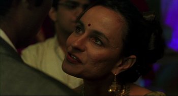 Movie still from “Monsoon Wedding” (2001), directed by Mira Nair – A person wearing a necklace; Close Up shot, Over the shoulder angle