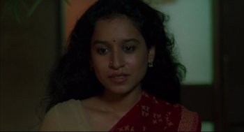 Movie still from “Monsoon Wedding” (2001), directed by Mira Nair – A woman in a red and yellow sari; Close Up shot, High angle