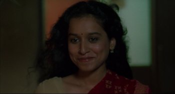 Movie still from “Monsoon Wedding” (2001), directed by Mira Nair – A person smiling for a picture; Close Up shot, High angle